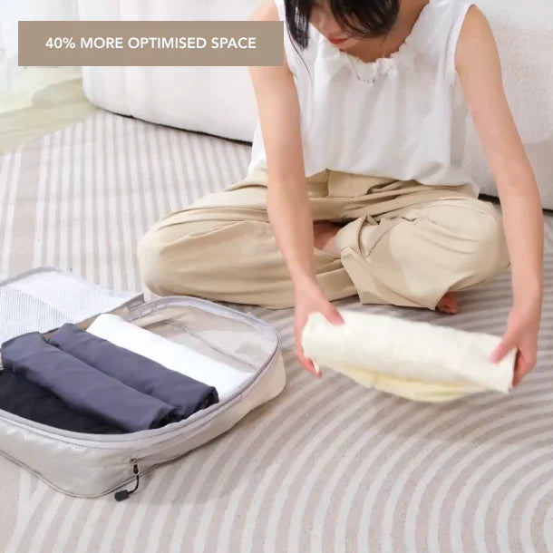Packing cube being compressed with clothing